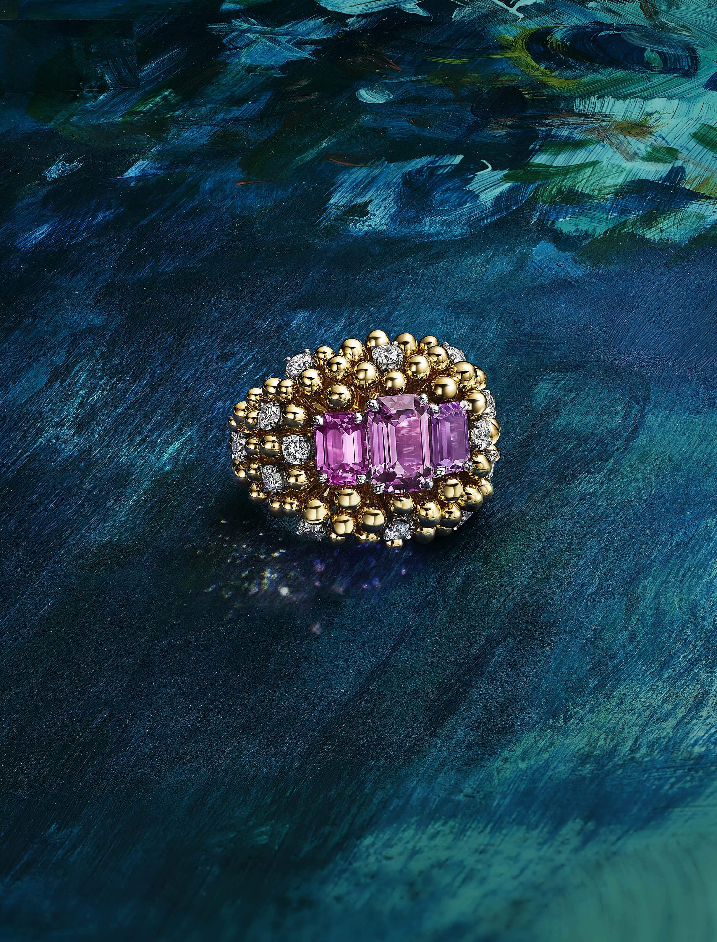 Bloom Unenhanced Pink and Purple Sapphire Ring Ring in platinum and 18k yellow gold with two unenhanced emerald-cut pink sapphires of 4.47 total carats, an unenhanced emerald-cut purple sapphire of 1.55 carats and diamonds