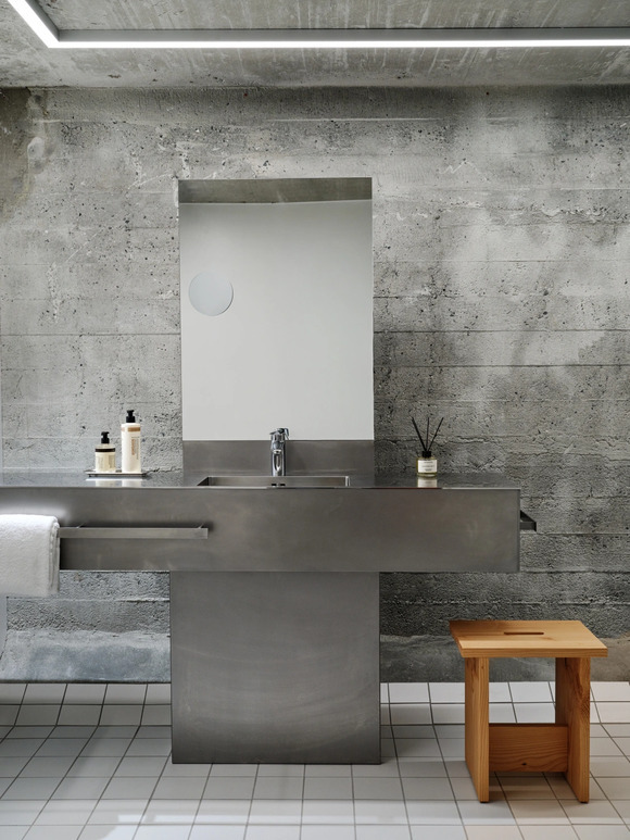 Bespoke steel interior in the bathrooms echo the building's industrial past.
