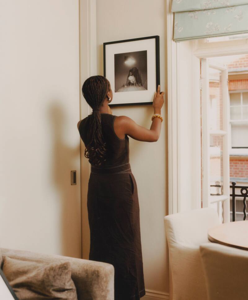 Alayo Akinkugbe with Untitled (Man and Mirror) by Carrie Mae Weems